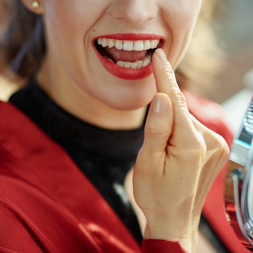 Woman pointing to her tooth