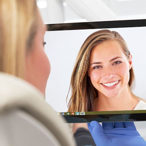 Woman looking at virtual smile design on chairside computer