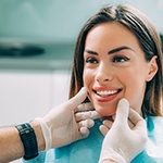 A dentist assessing a woman for cosmetic dentistry