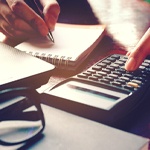 Woman calculating cost of dentures in Fort Worth