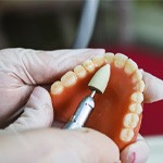A lab worker making dentures 