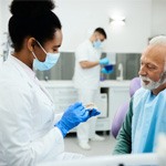 A dentist explaining what her patient should expect from dentures 