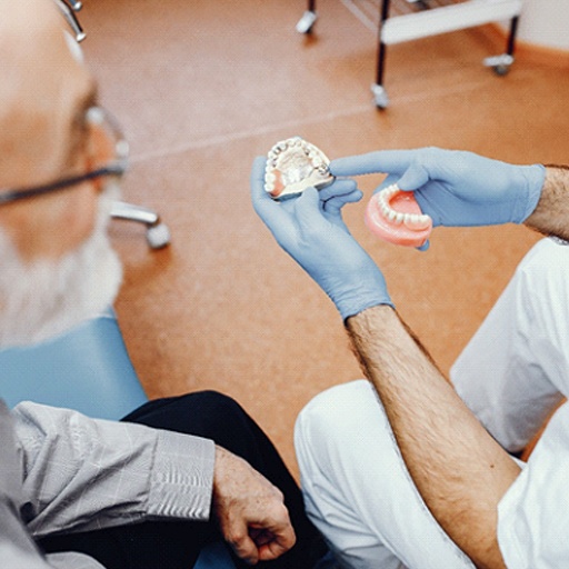 Fort worth dentist explaining dentures to his patient