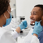 Male patient smiling at dentist during dental checkup
