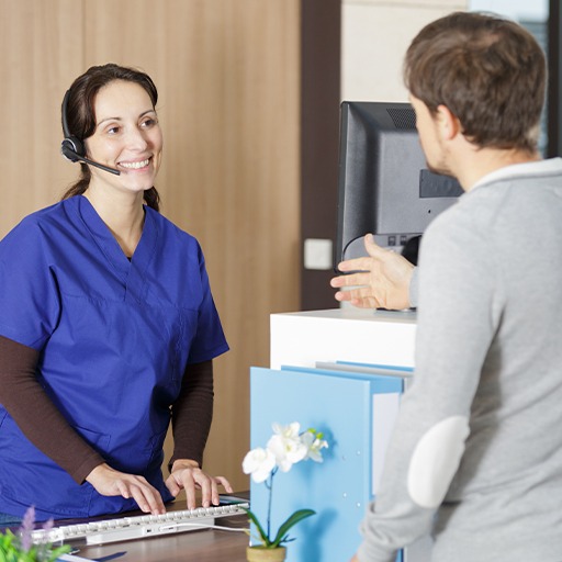 Patient and dental team member discussing the cost of dental emergencies