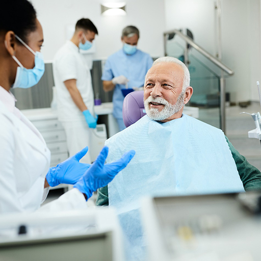 happy man talking to dentist about dental implants in Fort Worth