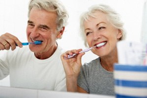 Father and child brushing teeth to prevent dental emergencies