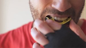 Father and child brushing teeth to prevent dental emergencies