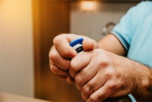 Father and child brushing teeth to prevent dental emergencies