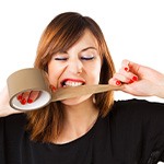 Patient in Fort Worth biting duct tape with dental implants
