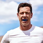 Patient in Fort Worth wearing mouthguard to protect dental implants