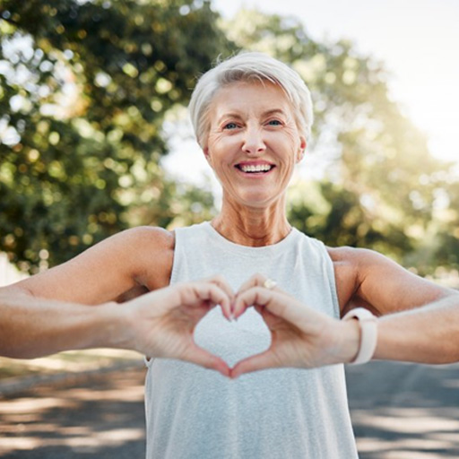 Lady makes shape of heart with her hands