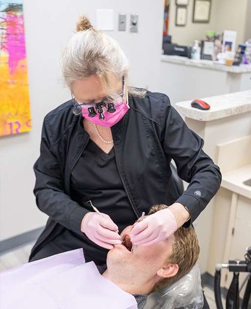 Man in dental chair smiling at dentist