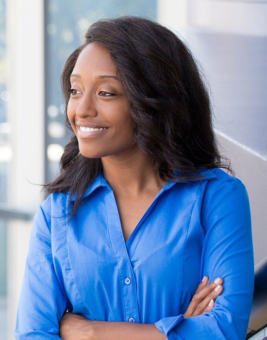 Woman smiling after replacing missing teeth