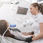 Dentist talking to patient with nitrous oxide mask over nose