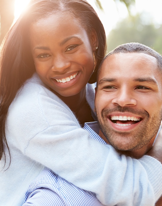 Man and woman smiling after sedation dentistry visit