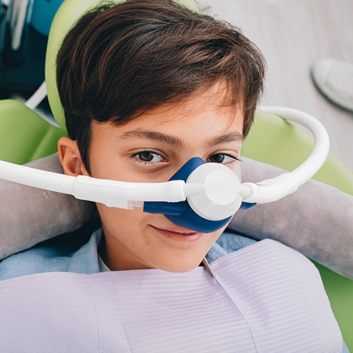 Child with nitrous oxide dental sedation mask