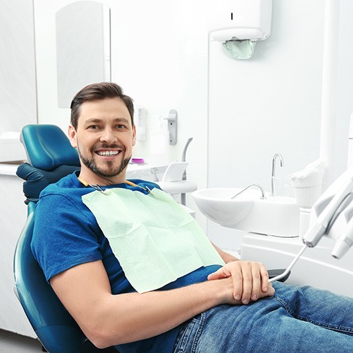 Woman leaning back in dental chair smiling