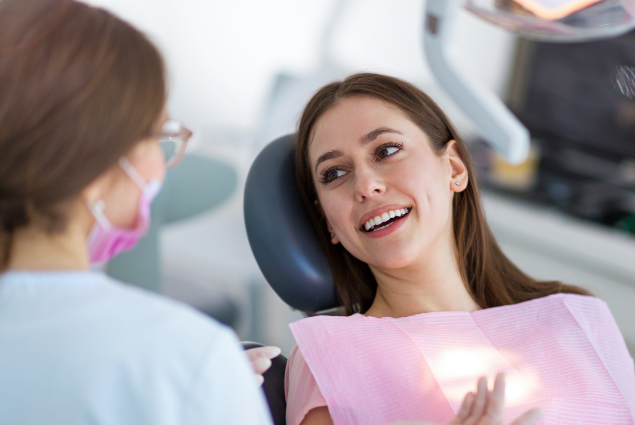 Woman smiling at dentist during dental exam