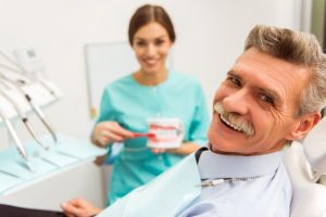 man with dentures at dentist 