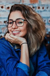 Woman with attractive smile resting chin in hand