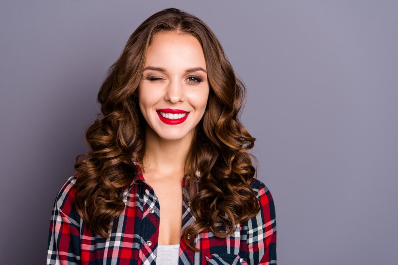 woman winking about how to get whiter teeth in Fort Worth