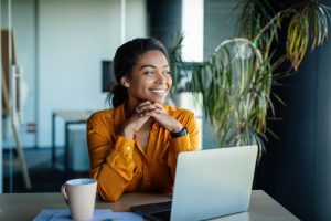 a business person smiling while sitting at a desk