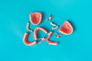 Partial dentures and dental bridges on a blue background