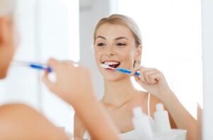 Woman brushing her teeth.